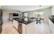 Open kitchen with a large island, stainless steel appliances, and a view into the living and dining areas at 10173 Skye Saddle Ave, Las Vegas, NV 89166