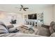 Open-concept living room with dining area, neutral walls, and comfortable furnishings at 10173 Skye Saddle Ave, Las Vegas, NV 89166