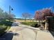 Scenic park view with lush greenery, mature trees, walking path, and community sports field, ideal for outdoor activities at 10173 Skye Saddle Ave, Las Vegas, NV 89166