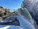 Paved walkway leading to a gated entrance with tiered landscaping, plantings, and trees at 10173 Skye Saddle Ave, Las Vegas, NV 89166