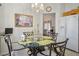 Bright breakfast nook features glass top table, decorative chandelier and access to other rooms at 10401 Sea Palms Ave, Las Vegas, NV 89134