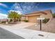 Inviting single-story home with a desert landscape, complemented by palm trees and a spacious driveway at 10401 Sea Palms Ave, Las Vegas, NV 89134