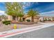 Well-maintained single-story home with desert landscaping, complemented by palm trees and a tidy lawn at 10401 Sea Palms Ave, Las Vegas, NV 89134