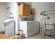 Functional laundry room with washer, dryer, storage cabinets, and a drying rack at 10401 Sea Palms Ave, Las Vegas, NV 89134