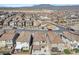 Aerial view of homes nestled in a large neighborhood with mountains in the distance at 10619 Carnes Ave, Las Vegas, NV 89166
