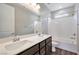 Bathroom featuring a double sink vanity with modern fixtures and a bathtub with white subway tile surround at 10619 Carnes Ave, Las Vegas, NV 89166