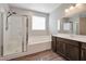 Modern bathroom featuring a separate shower, soaking tub, and double vanity at 10619 Carnes Ave, Las Vegas, NV 89166
