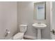 Powder room features modern fixtures including a pedestal sink and toilet at 10619 Carnes Ave, Las Vegas, NV 89166