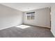 Bright bedroom with neutral carpet, natural lighting, and plenty of space at 10619 Carnes Ave, Las Vegas, NV 89166