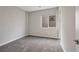This is a well lit bedroom with neutral carpet, a window with shade, and fresh white paint ready for decor at 10619 Carnes Ave, Las Vegas, NV 89166