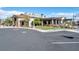 Community clubhouse featuring outdoor seating areas, a pergola, and manicured lawns at 10619 Carnes Ave, Las Vegas, NV 89166