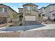 Two-story stucco home features a brick driveway, landscaped yard, and attached two-car garage at 10619 Carnes Ave, Las Vegas, NV 89166