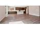 Open floor plan featuring wood-look floors, a kitchen island and dark wood cabinets at 10619 Carnes Ave, Las Vegas, NV 89166