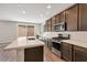 Modern kitchen featuring stainless steel appliances, white countertops, and brown cabinets at 10619 Carnes Ave, Las Vegas, NV 89166