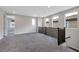 Upstairs loft area featuring neutral carpet, natural lighting, and plenty of space at 10619 Carnes Ave, Las Vegas, NV 89166