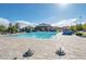 Resort-style community pool featuring pristine water, lounge chairs, and lush landscaping at 10619 Carnes Ave, Las Vegas, NV 89166