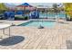 Community pool area features a fenced-in spa with a tiled deck and sunny skies at 10619 Carnes Ave, Las Vegas, NV 89166