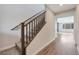 Bright hallway boasts wood-look floors, carpeted stairs with wood railing and natural light at 10619 Carnes Ave, Las Vegas, NV 89166