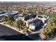 Aerial view of a home showcasing lush landscaping, solar panels, and a convenient circular driveway at 1484 Macdonald Ranch Dr, Henderson, NV 89012