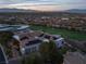 Aerial view of the property with solar panels on the roof, showcasing the home's sustainable features and design at 1484 Macdonald Ranch Dr, Henderson, NV 89012
