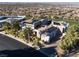 Aerial view of a modern residence showcasing solar panels, lush landscaping, and neighborhood views at 1484 Macdonald Ranch Dr, Henderson, NV 89012