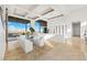 Sunlit dining area with a large glass table, seating for ten, and scenic outdoor views at 1484 Macdonald Ranch Dr, Henderson, NV 89012