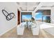 Elegant dining room featuring a glass table, stylish white chairs, and stunning city views at 1484 Macdonald Ranch Dr, Henderson, NV 89012
