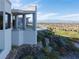 Stunning architectural view from the hillside showcasing the property's terraced landscaping and beautiful surrounding views at 1484 Macdonald Ranch Dr, Henderson, NV 89012