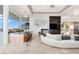 Bright open living room with fireplace, bar, large windows, and modern decor at 1484 Macdonald Ranch Dr, Henderson, NV 89012