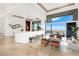 Bright open-concept living room featuring floor-to-ceiling windows with city views and stylish modern furnishings at 1484 Macdonald Ranch Dr, Henderson, NV 89012