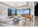 Bright living room with a large sectional sofa, city views, and a stylish bar area at 1484 Macdonald Ranch Dr, Henderson, NV 89012