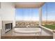 Luxurious bathroom with a soaking tub, fireplace, and expansive views at 1484 Macdonald Ranch Dr, Henderson, NV 89012