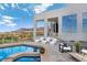 Beautiful pool area with comfortable lounge seating and panoramic views of the surrounding landscape at 1484 Macdonald Ranch Dr, Henderson, NV 89012