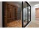 Well-stocked wine cellar with glass doors and adjacent sitting area at 1484 Macdonald Ranch Dr, Henderson, NV 89012