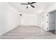 Open floor plan showcasing modern light-colored floors, complemented by white walls and a ceiling fan at 1613 Hartke Pl, Las Vegas, NV 89104