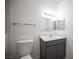 Clean, neutral bathroom featuring toilet, vanity, cabinet and mirror at 1704 N Jones Blvd, Las Vegas, NV 89108