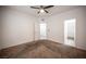 Bright bedroom features carpet, ceiling fan, walk-in closet, and an open doorway to the bathroom at 1704 N Jones Blvd, Las Vegas, NV 89108