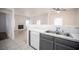 Open-concept kitchen featuring a serving bar, sink, and view into the living area with a fireplace at 1704 N Jones Blvd, Las Vegas, NV 89108