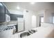 Compact kitchen features sleek gray cabinets, white appliances, and tiled countertops at 1704 N Jones Blvd, Las Vegas, NV 89108