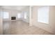 Spacious open-concept living space with tile floors, a fireplace, and bright windows at 1704 N Jones Blvd, Las Vegas, NV 89108