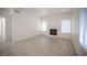 Open living room with tile floors, fireplace, and natural light from multiple windows at 1704 N Jones Blvd, Las Vegas, NV 89108