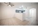 Bright and airy living space with tile flooring, connecting to a modern kitchen with gray cabinets at 1704 N Jones Blvd, Las Vegas, NV 89108