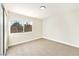 This neutral bedroom features plush carpeting and a large window at 2105 Cardigan Ave, North Las Vegas, NV 89032