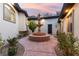 Charming courtyard with a central tiered fountain, flowering plants and a stamped concrete walkway at 211 Granite Ct, Boulder City, NV 89005