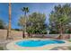 Lush backyard featuring a pool, mature trees, and a brick wall at 2724 Monrovia Dr, Las Vegas, NV 89117