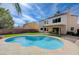 Spacious backyard features a sparkling pool, lush artificial grass, and privacy fencing at 2724 Monrovia Dr, Las Vegas, NV 89117