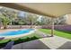 Inviting backyard with a covered patio, pool, and well-maintained artificial grass at 2724 Monrovia Dr, Las Vegas, NV 89117