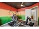 Bedroom with exercise equipment, painted walls, ceiling fan, and hardwood floors at 2724 Monrovia Dr, Las Vegas, NV 89117