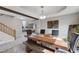 Stylish dining room features a wooden table, bench seating, elegant lighting, and hardwood floors at 2724 Monrovia Dr, Las Vegas, NV 89117