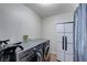 Bright laundry room featuring a modern washer and dryer, and ample storage space in a sleek cabinet at 2724 Monrovia Dr, Las Vegas, NV 89117